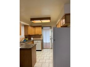 Surrey apartment for rent - A kitchen with a refrigerator, sink, and cabinets.