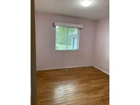 Surrey apartment for rent - A room with wooden flooring and a window with blinds.