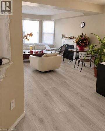 Waterloo apartment for rent - A living room with a white couch and a fireplace.