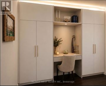 Toronto (Banbury-Don Mills) condo for rent - A white desk with a chair and a cabinet with shelves.