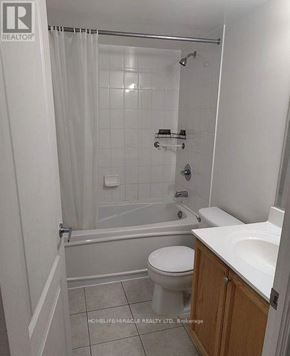 Mississauga (City Centre) condo for rent - A white bathroom with a toilet, sink, and bathtub.
