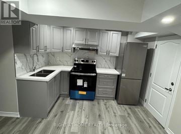 Oakville (Wm Westmount) apartment for rent - A kitchen with a blue bin in the middle.
