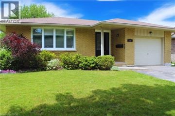 Kitchener apartment for rent - A house with a red roof and a white garage door.