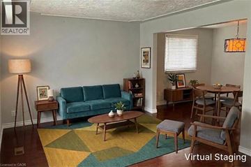 Kitchener apartment for rent - A living room with a blue couch and a wooden coffee table.