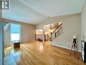 Ottawa apartment for rent - A room with wooden floors and a staircase.
