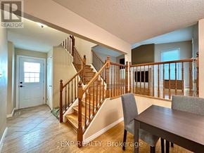 Ottawa apartment for rent - A wooden staircase with a white door and a window.