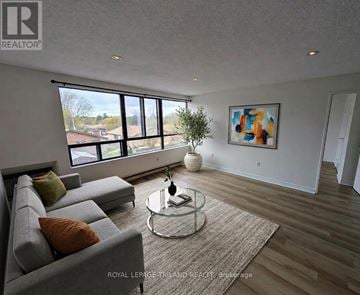 London South (South E) condo for rent - A living room with a grey sofa and a glass coffee table.