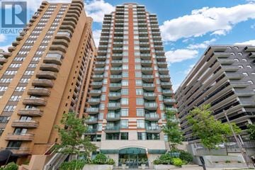 Ottawa condo for rent - A tall apartment building with a green awning in front.
