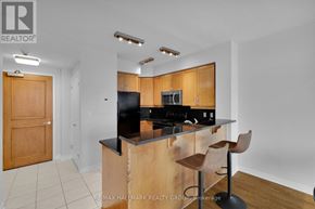 Ottawa condo for rent - A kitchen with a wooden island and bar stools.