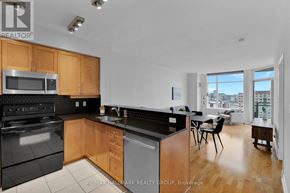 Ottawa condo for rent - A kitchen with wooden cabinets and black appliances.