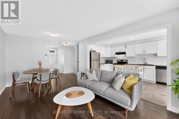 Ottawa townhouse for rent - A modern living room with a grey couch and a wooden coffee table.