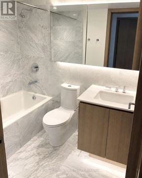 Toronto (Waterfront Communities) condo for rent - A white toilet sits in a bathroom with a marble floor.