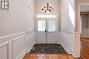 Vaughan (Vellore Village) apartment for rent - A hallway with a chandelier, a door with blinds, and a brokerage logo.