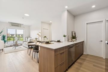 Edmonton apartment for rent - A modern kitchen with wooden cabinets and a white countertop.
