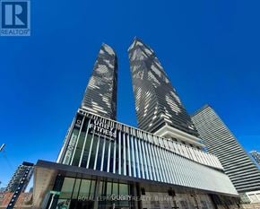 Toronto (Waterfront Communities) condo for rent - A tall building with the words "QUYNY FITNESS" on it.