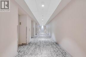 Toronto (Waterfront Communities) condo for rent - A long hallway with a tiled floor and white walls.