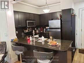 Vaughan (Maple) condo for rent - A kitchen with a counter and chairs.