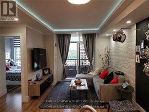 Vaughan (Maple) condo for rent - A living room with a couch, a coffee table, and a television.