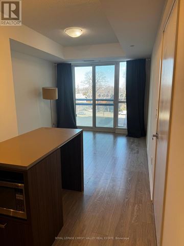 Toronto (High Park North) condo for rent - A kitchen area with a microwave and a refrigerator.