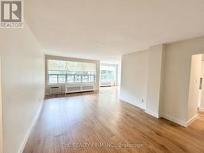 London South (South F) condo for rent - A spacious room with wooden flooring and a large window.