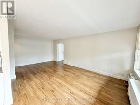 London South (South F) condo for rent - A room with wooden flooring and white walls.