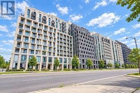 Toronto (Clanton Park) condo for rent - A large, modern apartment building with many windows and balconies.