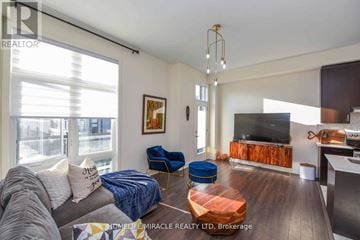 Vaughan (Vellore Village) townhouse for rent - A living room with a grey couch and a blue chair.