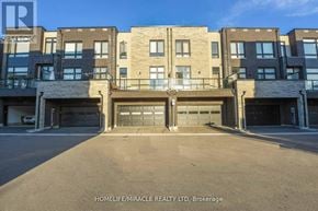 Vaughan (Vellore Village) townhouse for rent - A building with a clear blue sky in the background.