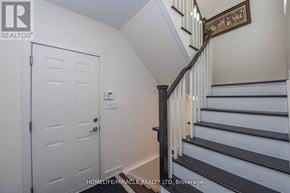 Vaughan (Vellore Village) townhouse for rent - A staircase with a wooden handrail and white steps.