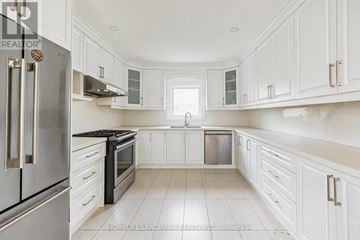 Toronto (Dorset Park) apartment for rent - A kitchen with white cabinets and a stainless steel refrigerator.