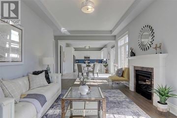 Oakville (Jm Joshua Meadows) apartment for rent - A living room with a white couch and a coffee table in the middle.