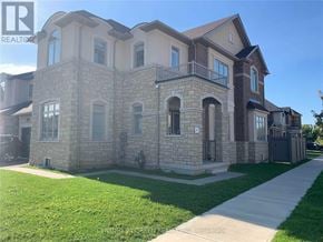 Oakville (Jm Joshua Meadows) apartment for rent - A large, two-story house with a stone exterior and a balcony on the second floor.