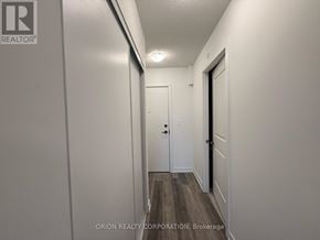 Toronto (Yorkdale-Glen Park) condo for rent - A hallway with a door on the right and a wall on the left.