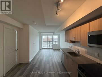 Toronto (Yorkdale-Glen Park) condo for rent - A kitchen with wooden floors and a large window.