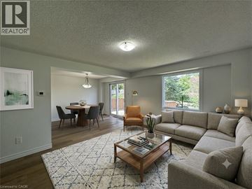 Cambridge apartment for rent - A living room with a grey couch, a coffee table, and a dining table with chairs.