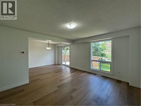 Cambridge apartment for rent - A room with wooden floors and a window overlooking a fence.