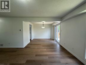 Cambridge apartment for rent - A long, empty room with wood flooring and white walls.
