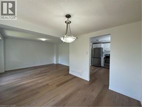 Cambridge apartment for rent - A well lit room with wooden floors and a chandelier.