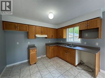 Cambridge townhouse for rent - A kitchen with wooden cabinets and a sink.