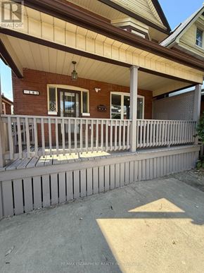 Hamilton (Gibson) apartment for rent - A house with a porch and a sign that says REMAX ESCARPMENT REALTY INC.