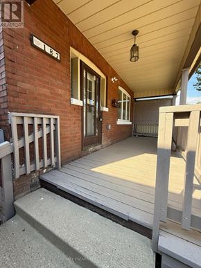 Hamilton (Gibson) apartment for rent - A porch with a wooden floor and a brick wall.