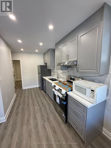 Hamilton (Gibson) apartment for rent - A kitchen with a white microwave oven on a counter.