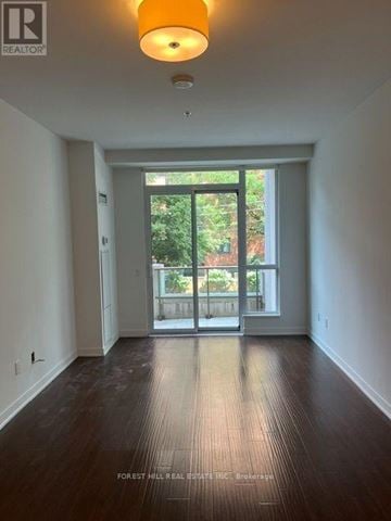 Toronto (Forest Hill South) house for rent - A room with a wooden floor and a sliding glass door leading to a balcony.