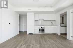 Toronto (Thorncliffe Park) condo for rent - A spacious kitchen with white cabinets and a wooden floor.