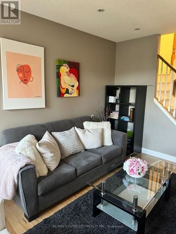 London North (North B) townhouse for rent - A living room with a grey couch and a glass coffee table.