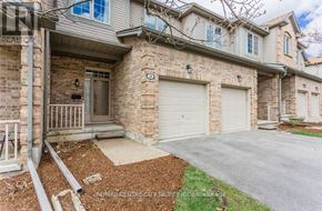 London North (North B) townhouse for rent - A house with a garage and a driveway in front.