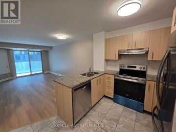 Toronto (Church-Yonge Corridor) condo for rent - A kitchen with wooden cabinets and a granite countertop.