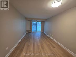 Toronto (Church-Yonge Corridor) condo for rent - A room with wooden floors and a window with a view of a street.
