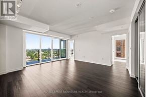 Toronto (Humber Heights) condo for rent - A spacious room with wooden floors and large windows overlooking a body of water.