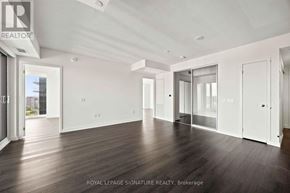 Toronto (Humber Heights) condo for rent - A spacious room with wooden floors and white walls, ready for a new tenant.